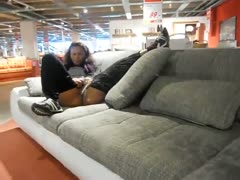 In the midst of the furniture store, the curly wife begins to urinate.